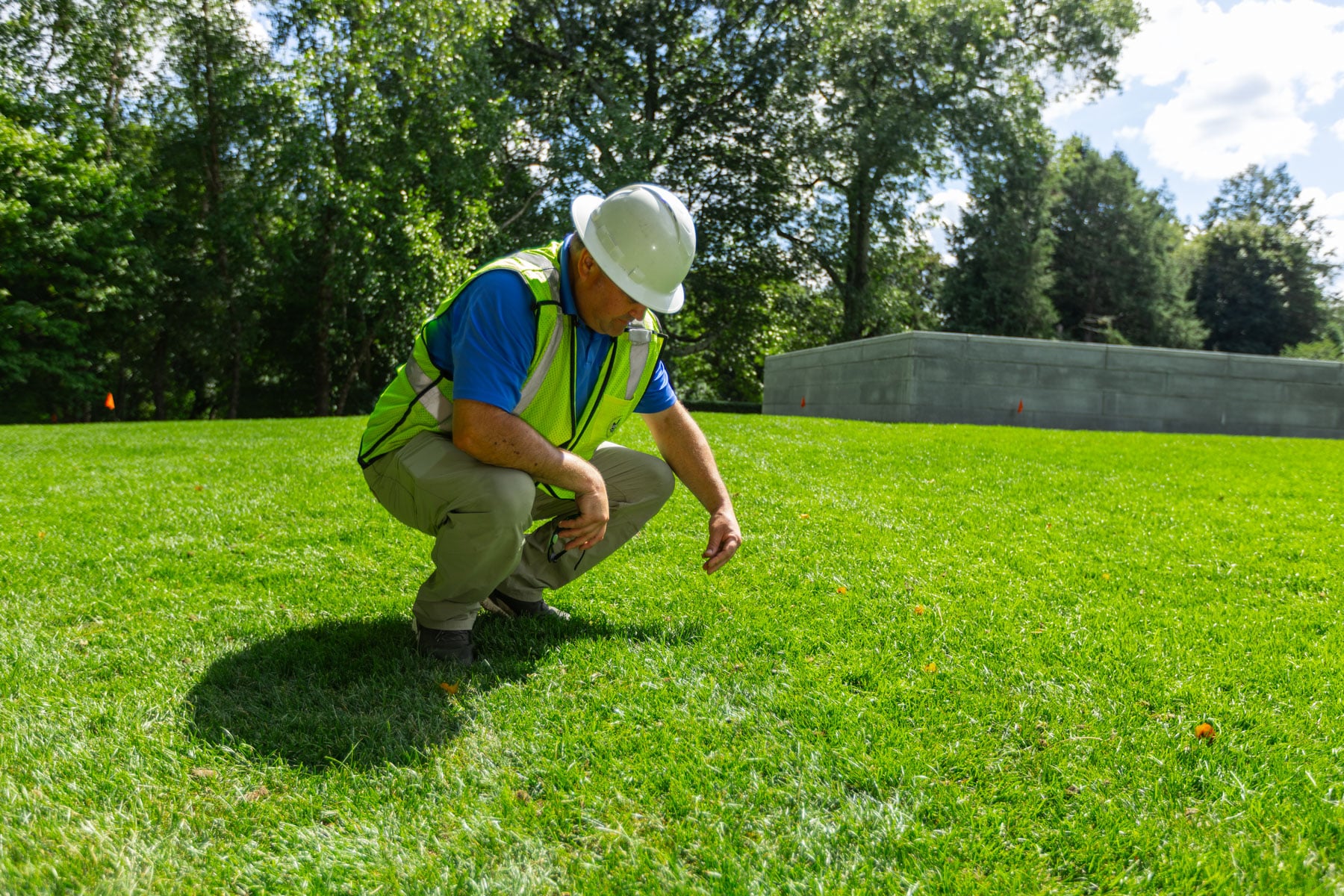 barrett-tree-service-lawn-care-technician-inspecting-grass-turf-day2-174